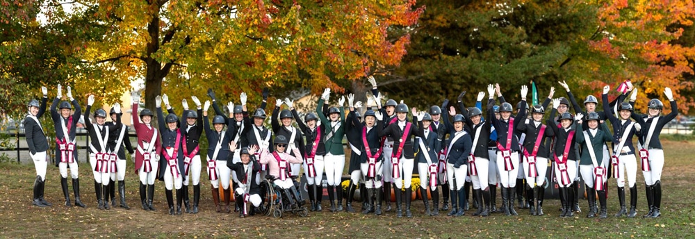 A large group of dressage riders at a show.