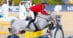 A man jumping a grey horse over a fence in Barcelona.